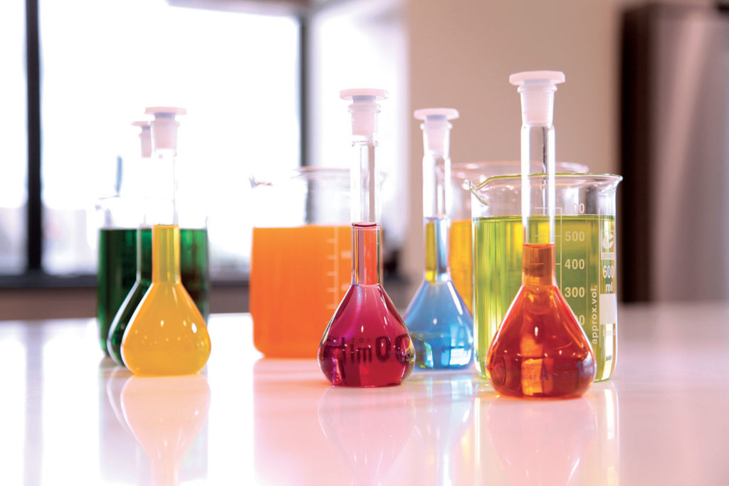 Picture of natural food colors and caramel color sources in beakers